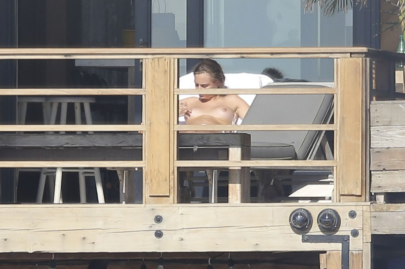 Cara Delevingne Topless Sunbathing on Vacation