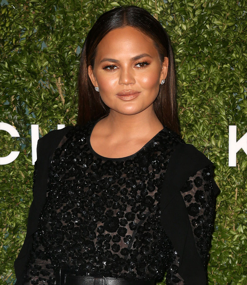 Chrissy Teigen Braless in See Through Black Blouse