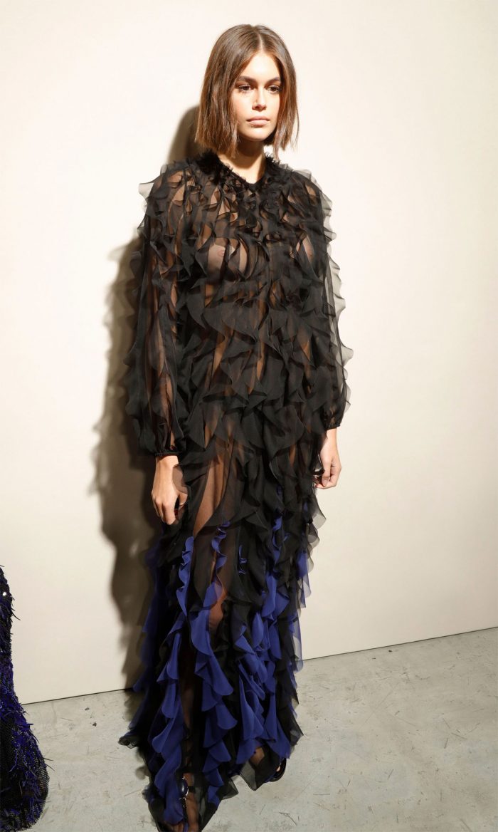 Kaia Gerber Braless Breasts in Black Lace Dress at a Fashion Show